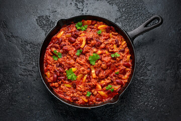 Vegetarian vegan mince chili con carne served in cast iron skillet pan