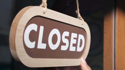Small business close. Turning the sign to closed