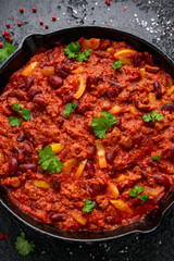 Vegetarian vegan mince chili con carne served in cast iron skillet pan