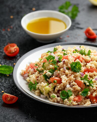 Tabbouleh salad with tomato, cucumber, red onion, bulgur and parsley. Healthy vegan food