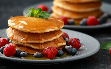 American pancakes with fresh blueberry, raspberry and honey. Healthy morning breakfast