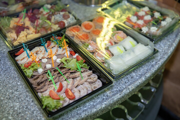 A table with snacks and food for a party in the party bass. Fruits. Sushi rolls. Wedding.