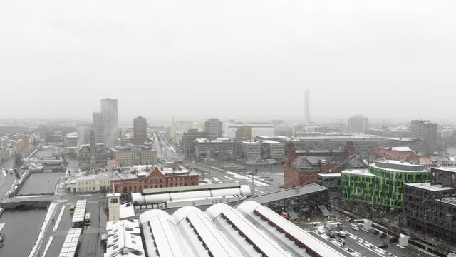 Drone flying over Malm&ouml; Central Station while it is snowing. Turning torso, Clarion Hotel in background