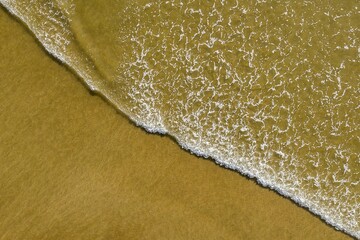 wave rolling out at beach