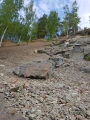 Gray granite stones lie on the slope