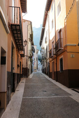 Fototapeta na wymiar cosy beautiful narrow street in old spanish town Xativa, province of Valencia