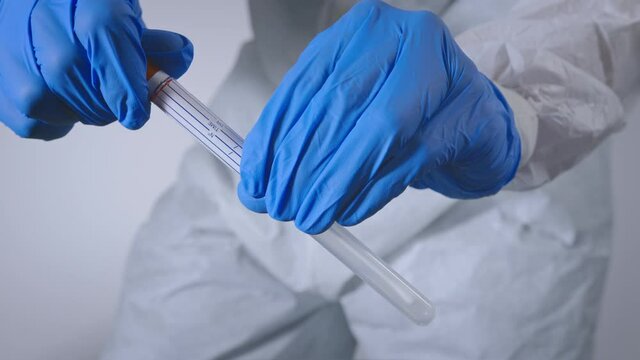 Nurse testing for Coronavirus with nasal swab test in a laboratory. Covid-19 virus pandemic.