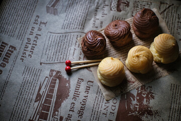Two-color Eclair, placed on cooking paper, delicious dessert in leisure time.