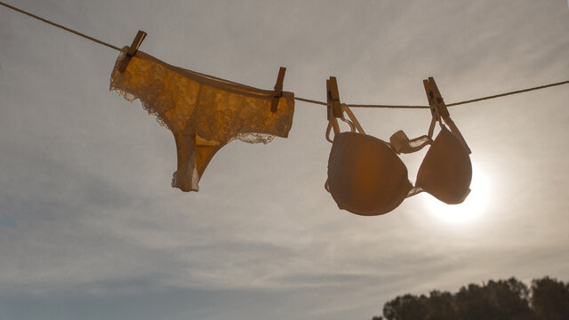 Woman's panties and bra hanging on clothes lines