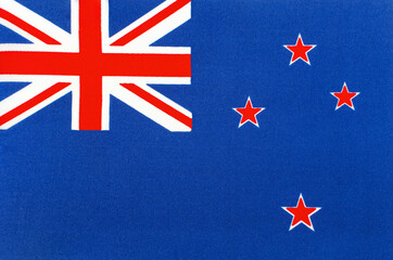 New Zealand national flag close-up on fabric base