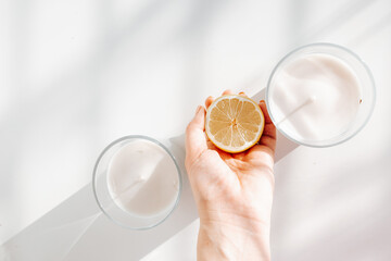 Two candles with yellow lemons for healthy and holistic living