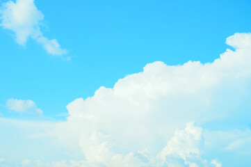View of beautiful white clouds in a blue sky,blue sea on sunny day with cloudy sky over it.