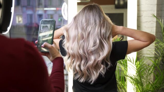 woman takes off on phone beautiful curly blonde hair model