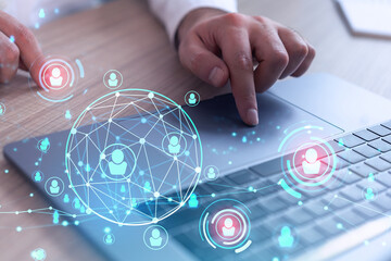 Hands of hr specialist is typing the keyboard in the internet to find the best candidates to create...