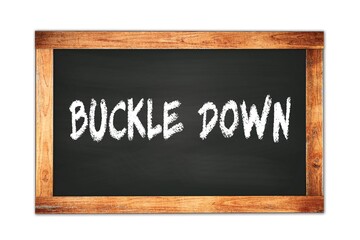Obraz premium BUCKLE DOWN text written on wooden frame school blackboard.