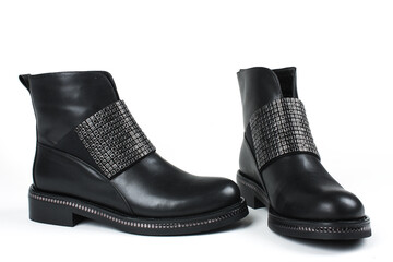 Women's black leather shoes with clasp and rhinestones on a white background