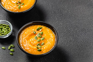Curried pumpkin soup on dark background.Space for text.