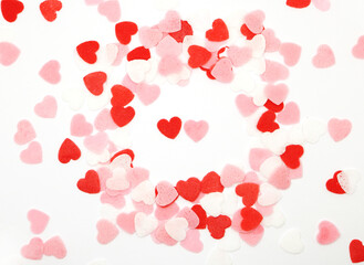 Obraz na płótnie Canvas Red pink and white hearts on a white background. Valentine's day concept. Selective focus. Postcard. Background.