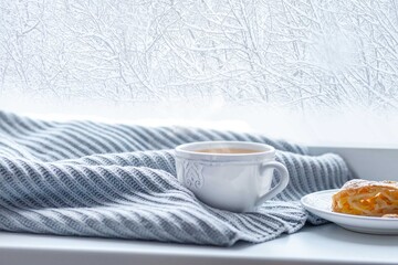 Winter composition of a cup of tea near the window.