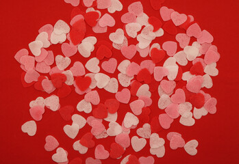 Red pink and white hearts on a red background. Valentine's day concept. Selective focus. Postcard. Background.