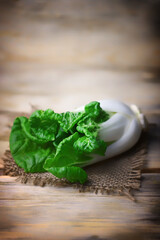Selective focus. Macro. Fresh bok choy cabbage on a wooden surface.