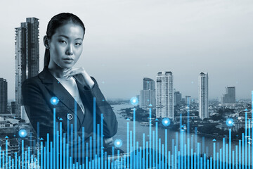 Attractive young Asian businesswoman in suit pondering about new approaches to consultancy to find...