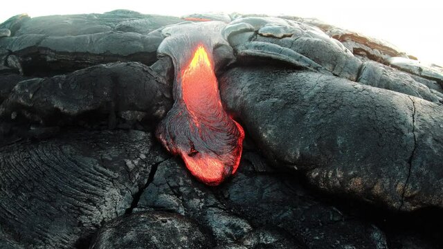 Pahoehoe lava flowing slowly from active volcano, Hawaii