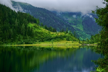 wonderful reflection in a mountain lake with green hills