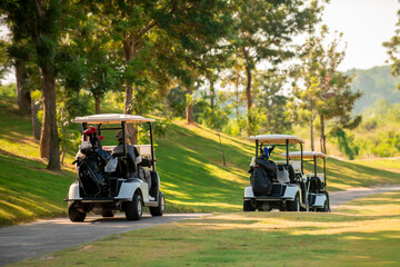 Golfer driving golf car on road in golf course