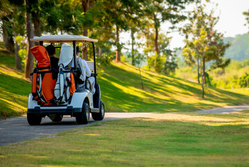 Golfer driving golf car on road in golf course