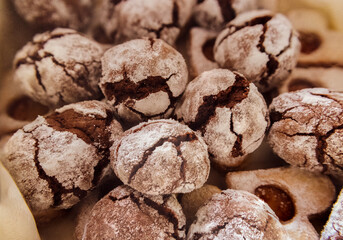 Sweet, Christmas home made cookies with chocolate cracks and sugar icing on the top