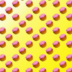 Cupcakes with white and pink cream on a yellow and white background, flat layout, pattern, wallpaper, banner, template
