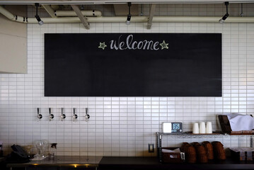 Chalkboard on Tiles Ceramic Wall in Coffee Shop.
