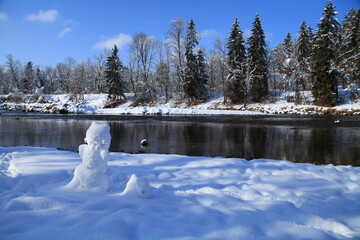 snow man isar river in munich germany snow cold ice winter season wild forest with beautiful nature landscape blue sky