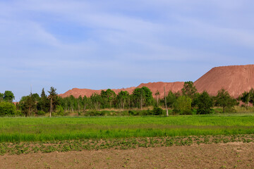 open pit for mining red granite in spring
