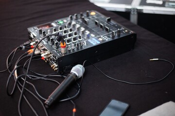 microphone and sound board with tangled cables at party hall