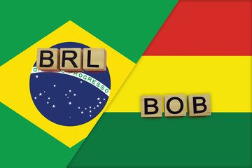 Brazil and Bolivia currencies codes on national flags background