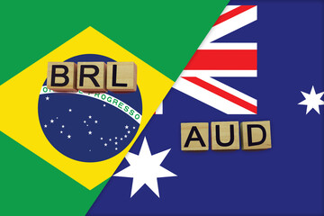 Brazil and Australia currencies codes on national flags background