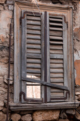 Damaged wooden window at Anafiotika of Athens