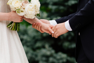 close up. newlyweds hold hands. happy bride and groom.