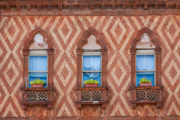Three beautiful windows of an old palazzo building, Venice, Italy