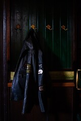 black leather jacket hanging in dimly lit pub setting