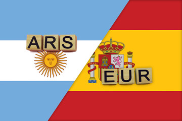 Argentina and Spain currencies codes on national flags background
