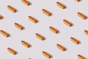 Hot dog pattern on a gray pink background. Creative art.