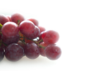 Fototapeta premium Ripe juicy red grapes on a white background