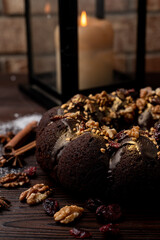 Round christmas fruit cake with nuts and found gold on top, close up
