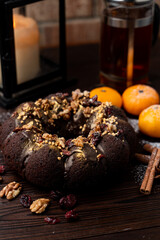 New year european bakery chocolate fruit cake with nuts, soaked with rum, atmospheric photo for a recipe magazine