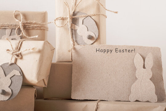 greeting card with Easter and gift boxes with a tag in the shape of a hare. zero waste gift. High quality photo