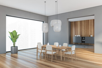 Grey and wooden room with beige chairs and dining table on parquet floor