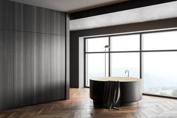 Wooden and gray bathroom corner with round bathtub